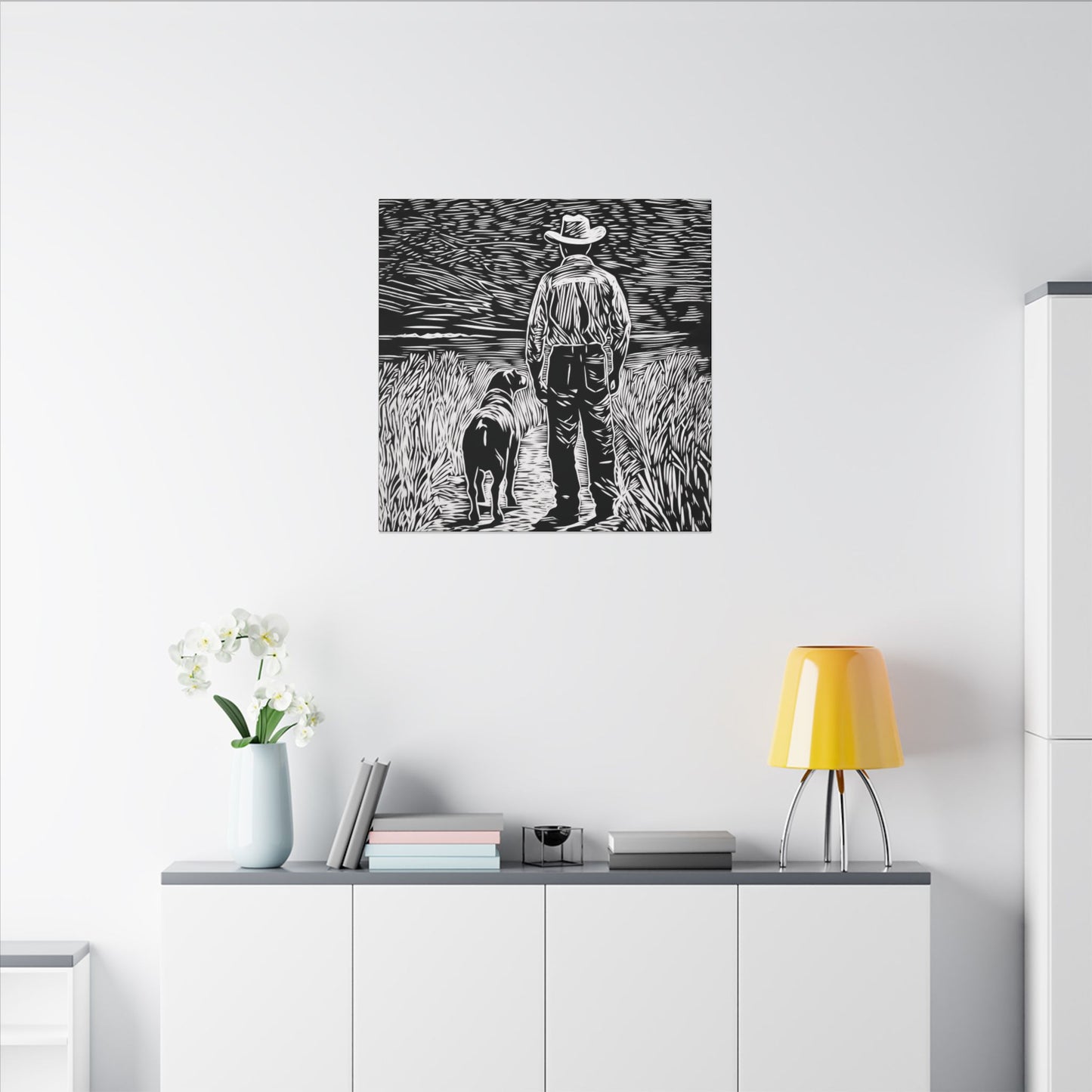 Second alternate room view. Canvas print in linocut style showing a cowboy and his dog standing side by side on a country path, gazing toward the horizon in black and white.