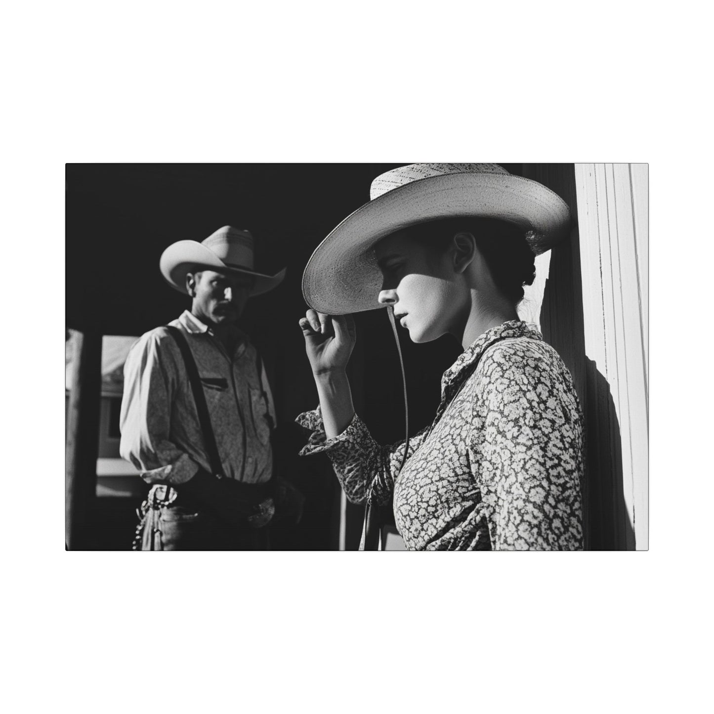 Full crop. Black and white canvas print of a cowgirl tipping her hat as a cowboy looks on from the shadows, evoking mystery and classic Western emotion.