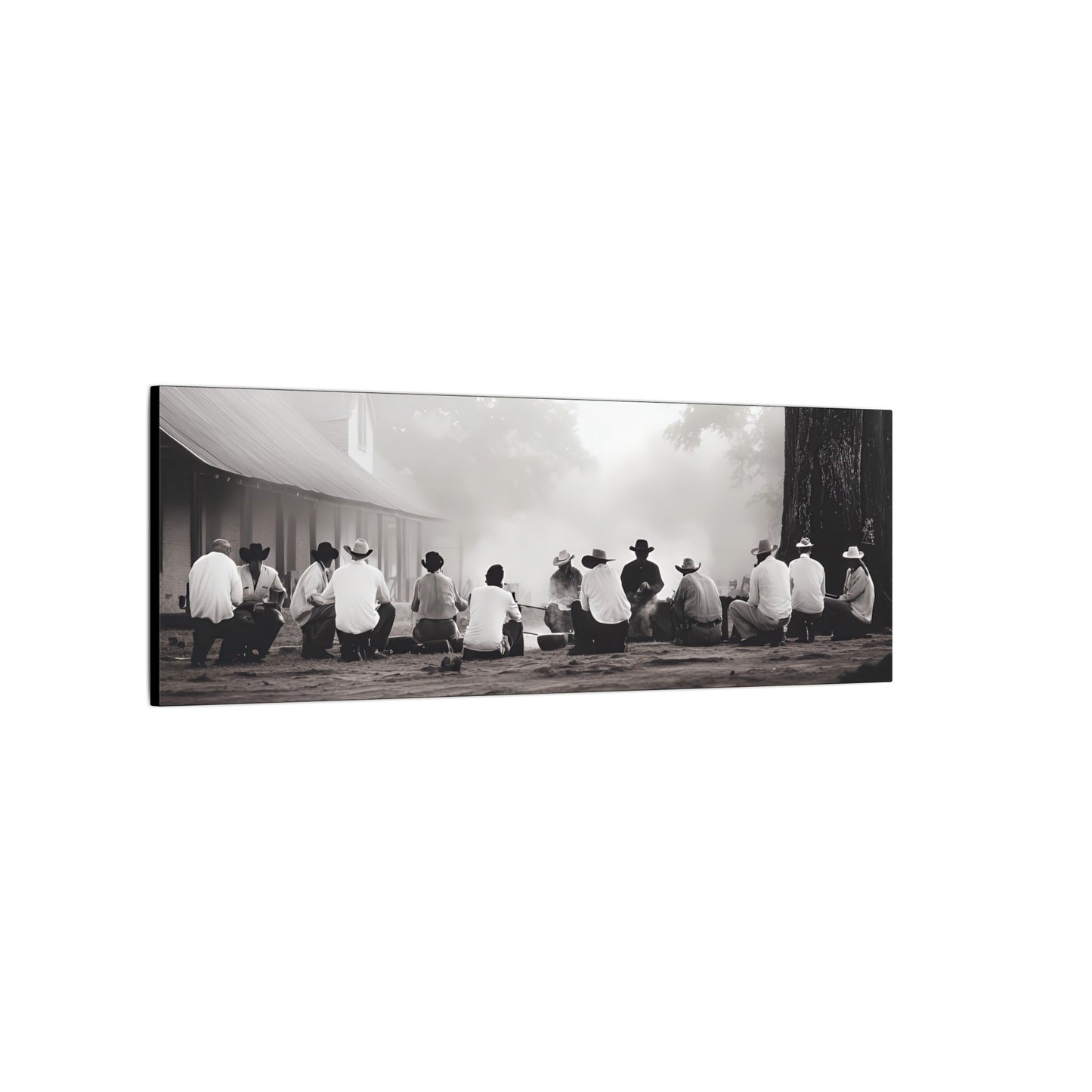 Side view. Western black and white canvas print of cowboys sitting in a circle around a smoking campfire near a rustic building, evoking tradition and camaraderie.