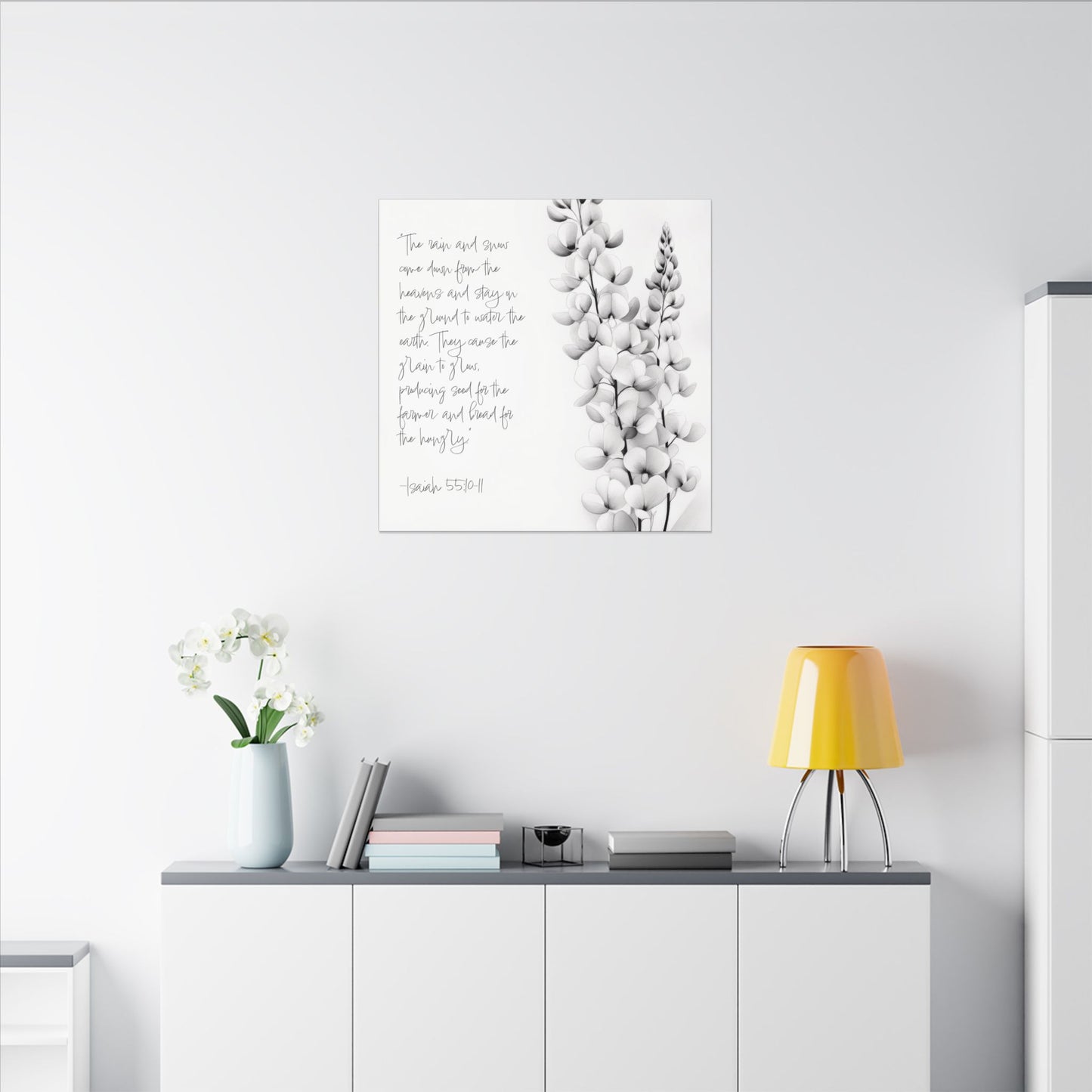 Second alternate room view. Canvas print with Isaiah 55:10–11 scripture in handwritten text beside a delicate black-and-white botanical flower sketch.