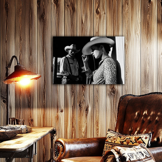 Room view.
Black and white canvas print of a cowgirl tipping her hat as a cowboy looks on from the shadows, evoking mystery and classic Western emotion.