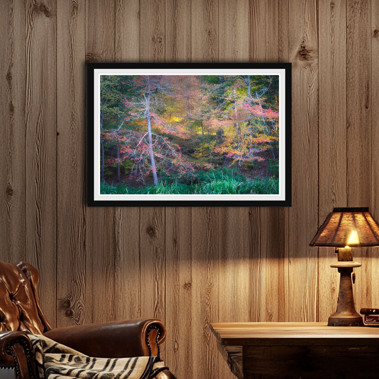 Black frame in room, Autumn Light, Vibrant autumn forest with red, orange, and yellow leaves glowing in soft afternoon light, framed fine art nature photograph.
