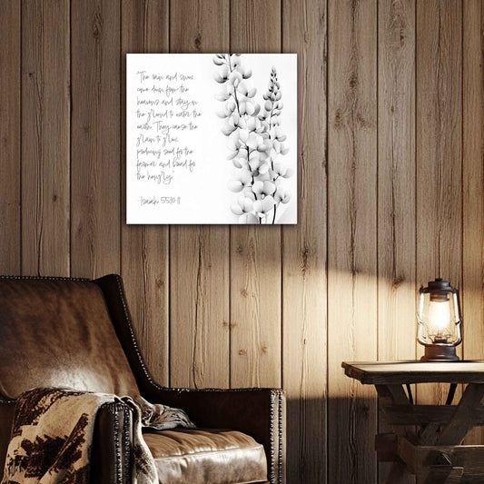 Room view. Canvas print with Isaiah 55:10–11 scripture in handwritten text beside a delicate black-and-white botanical flower sketch.