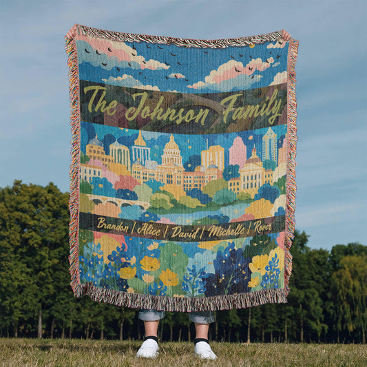 Medium shown. Personalized Austin woven blanket with colorful city skyline, Texas Capitol, wildflowers, and customizable family name and member names.