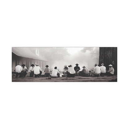 Western black and white canvas print of cowboys sitting in a circle around a smoking campfire near a rustic building, evoking tradition and camaraderie.