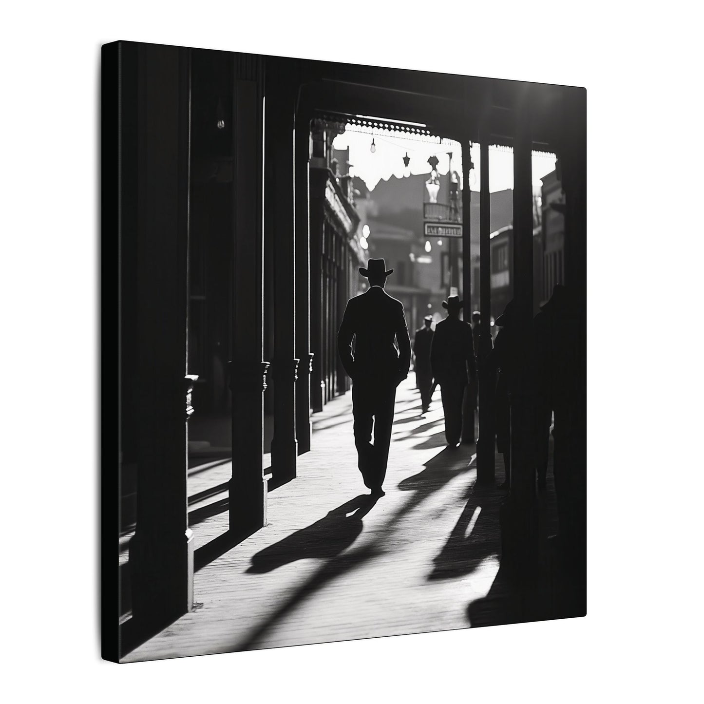 Side view. Canvas print of a silhouetted cowboy walking down a wooden sidewalk in a Western town, with long shadows and dramatic black-and-white lighting.