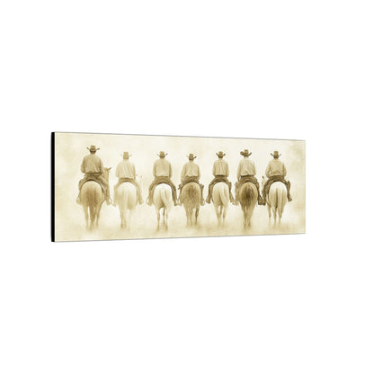 Side view. Sepia-toned art print featuring seven cowboys on horseback riding away in unison through a dusty Western town.