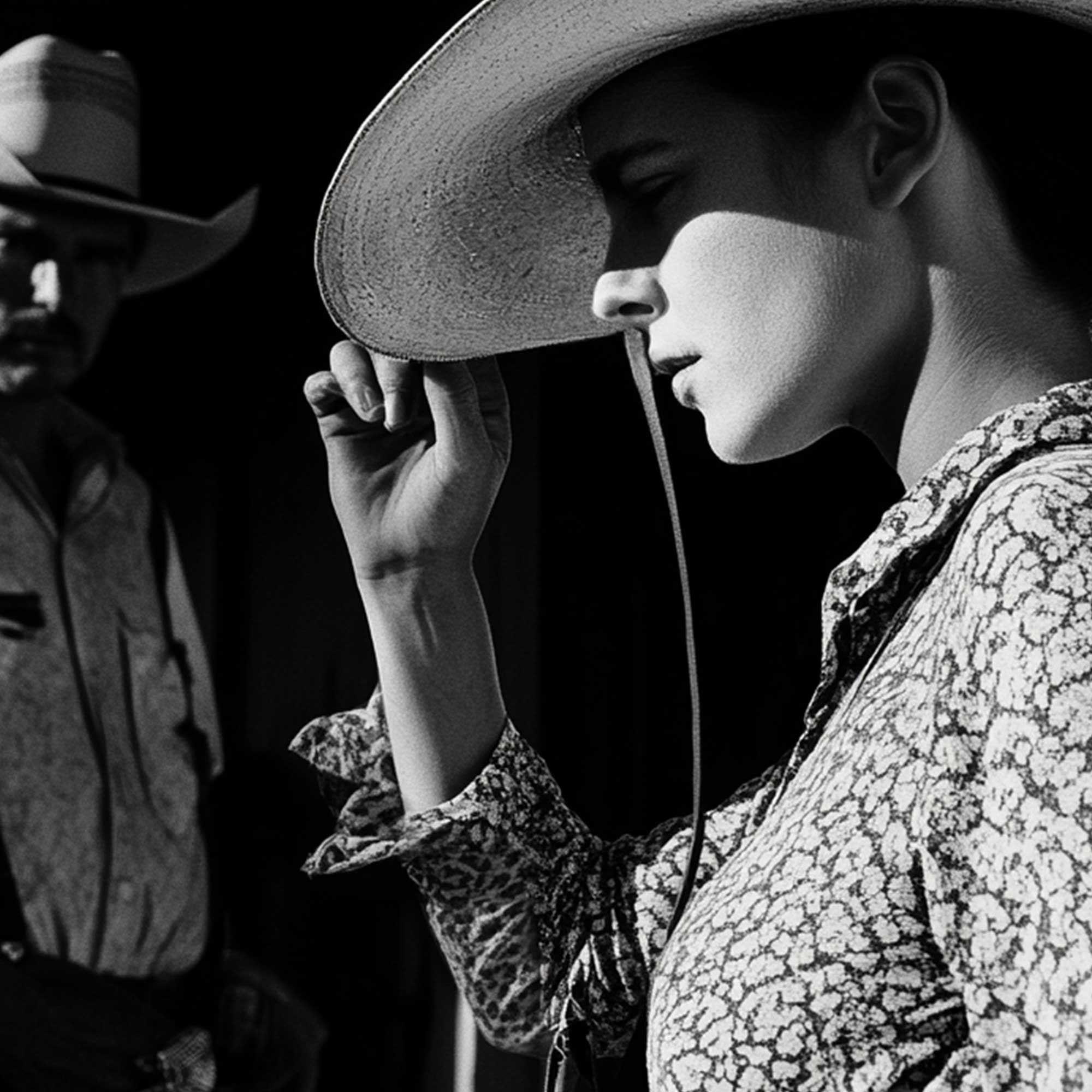 Black and white portrait of Texas cowgirl with hat, classic Western style