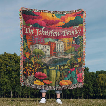 Medium size. Colorful heirloom woven blanket with the San Antonio skyline, River Walk, blooming Texas wildflowers, and customizable family names.